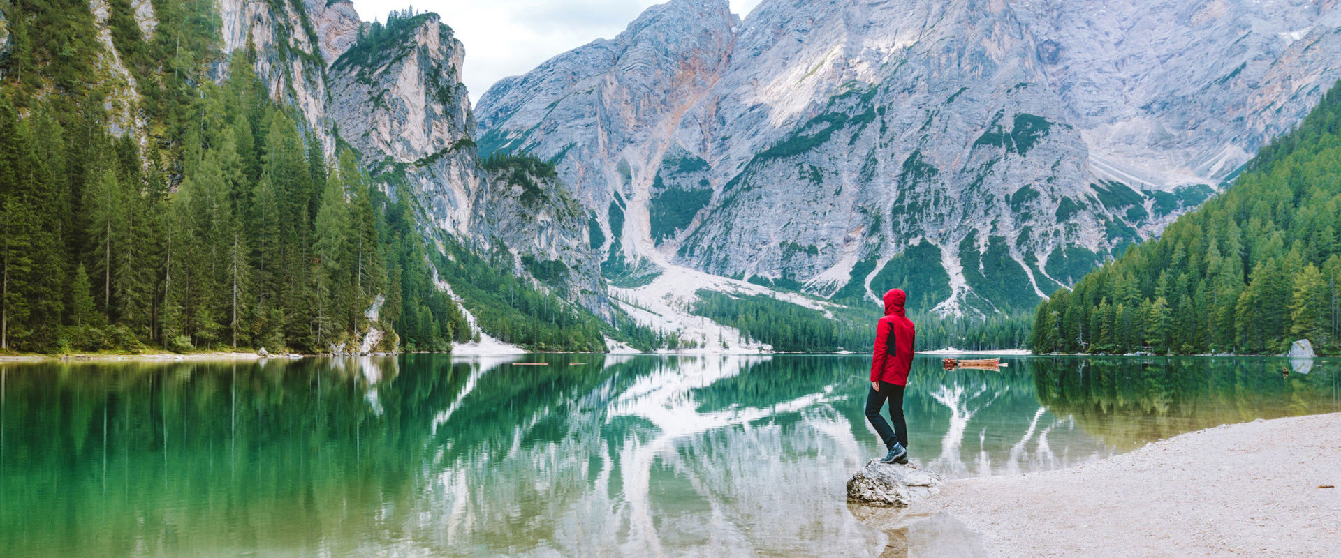 Lake Prags Hiker at Lake Prags with Mt. Seekofel