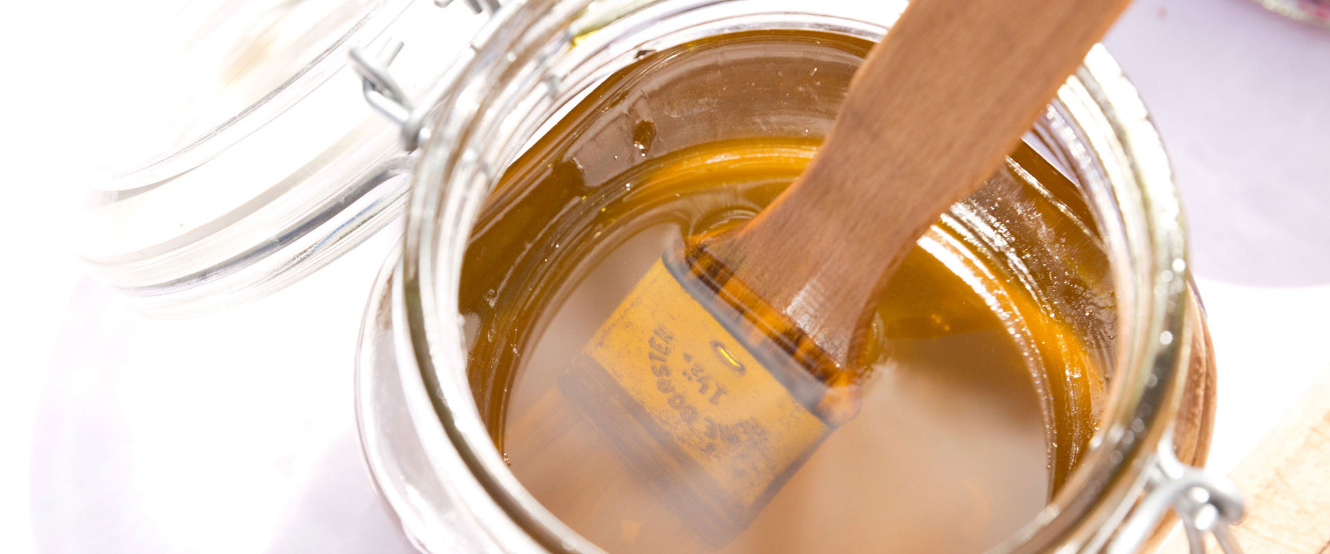 Honey Glass jar with honey and brush.
